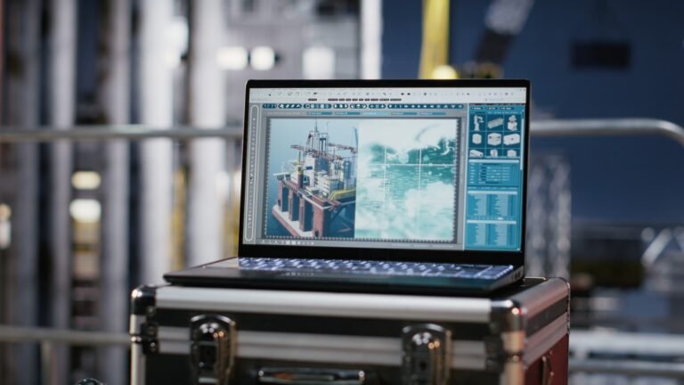 Laptop screen shows visualization monitoring software on empty offshore platform